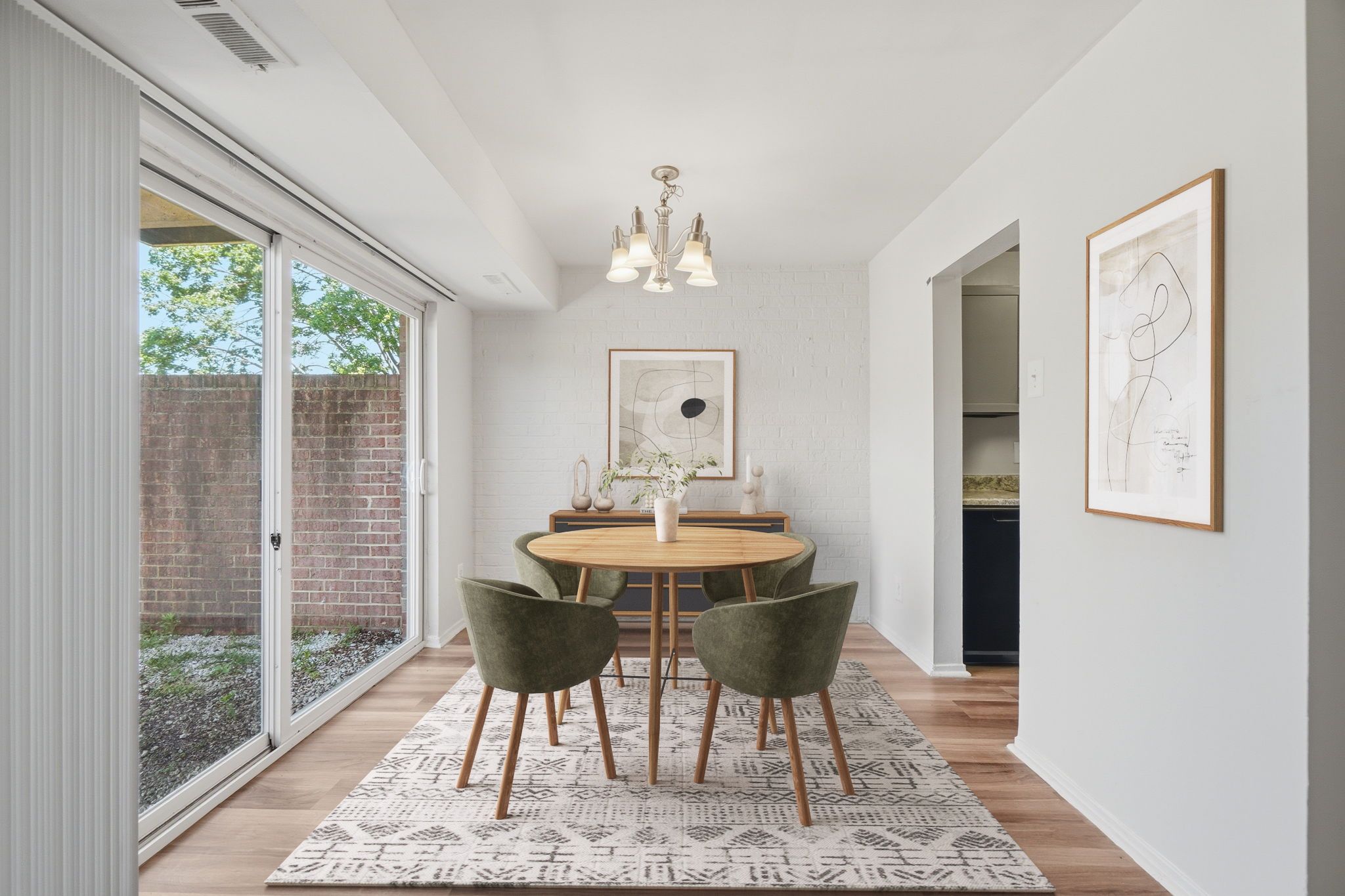 A dining room with a table and chairs.